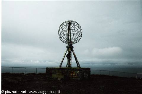 the steel North Cape globe monument on the cliff under a cloudy sky
