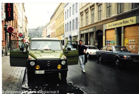 Man beside a green Mercedes G-Wagen parked on Oslo street