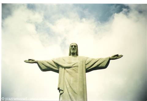 Christ the Redeemer statue with open arms among clouds in Rio de Janeiro