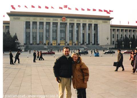 Smiling tourist couple in front of the Great Hall of the People, Beijing