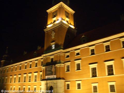 Warsaw's Royal Castle lit up at night with its clock tower