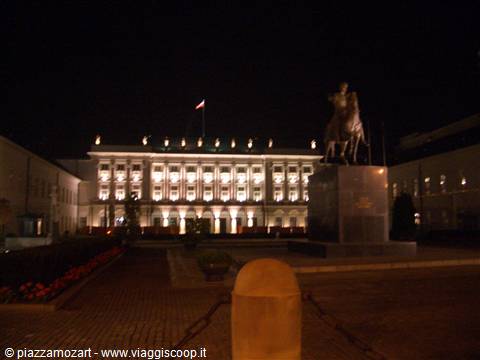 Warsaw Presidential Palace lit at night with Poniatowski's equestrian statue
