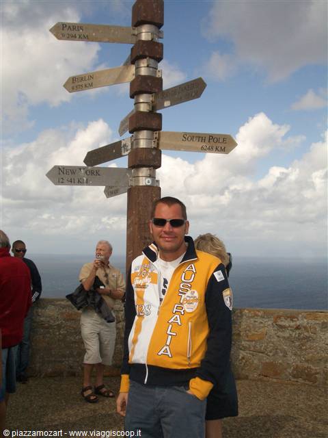 Tourist in Australia jacket at the distance signpost, Cape of Good Hope