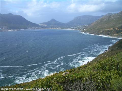 Hout Bay, white waves in the bay surrounded by mountains and greenery