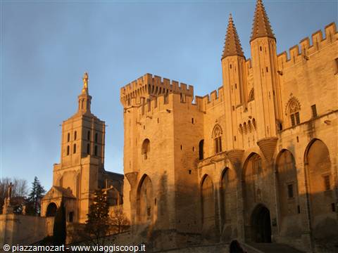 The Papal Palace of Avignon in golden stone at sunset