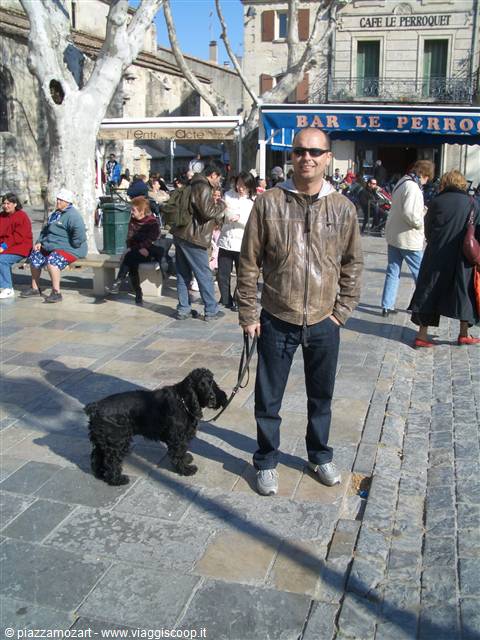 Man with black dog on square outside Bar Le Perroquet, Arles