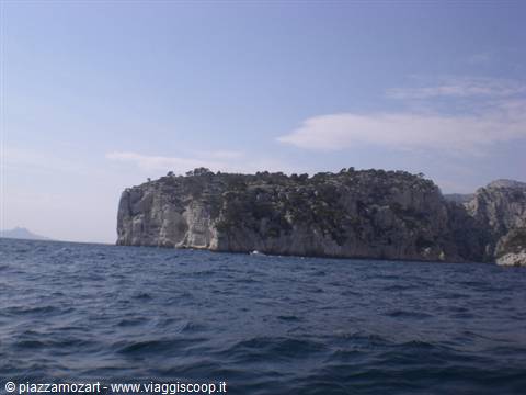 Limestone cliffs above blue sea in the Calanques, seen from a boat