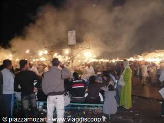 Crowd among smoke and food stall lights at night, Jemaa el-Fna