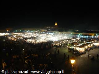 Jemaa el-Fna square at night with lit food stalls and crowds