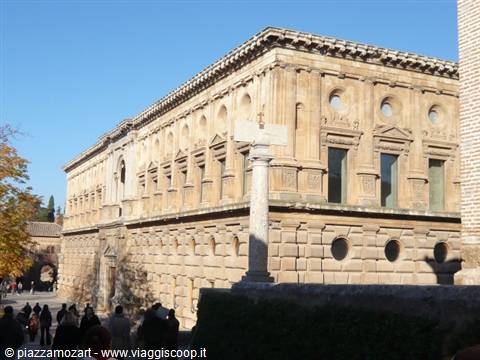 Tourists in front of Charles V Palace, golden stone under sunlight