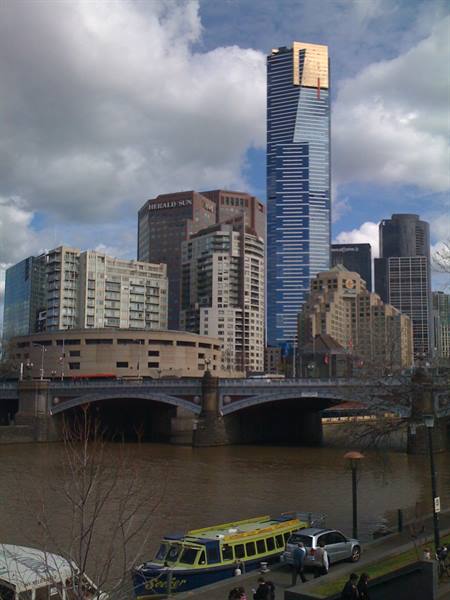 Eureka Tower above the bridge over the Yarra River, Melbourne, cloudy sky