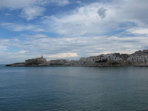 White old town of Vieste overlooking the Adriatic Sea under cloudy skies