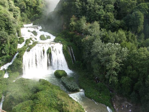 Marmore Falls: white cascades rushing through lush greenery, visitors on trails