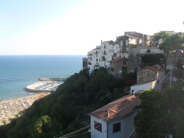 White houses of Sperlonga on the cliff above beach and harbor