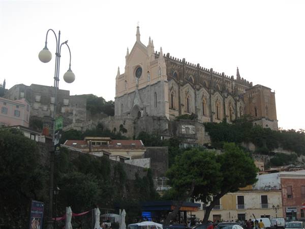 Gaeta cathedral rises above the buildings, with street lamps and tree-lined streets