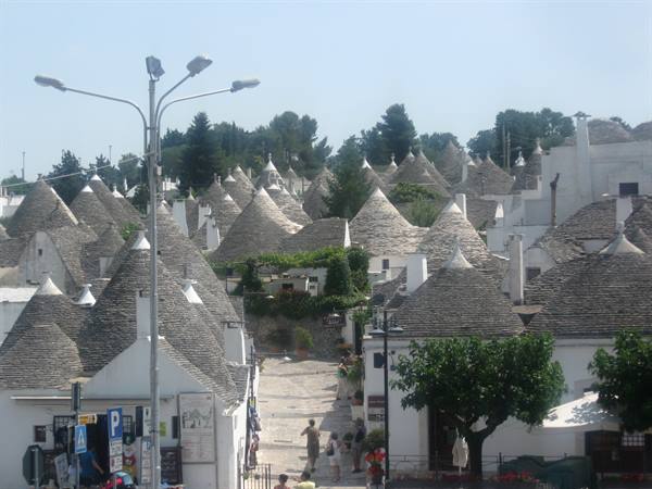 Trulli houses of Alberobello with stone conical roofs in sunlight