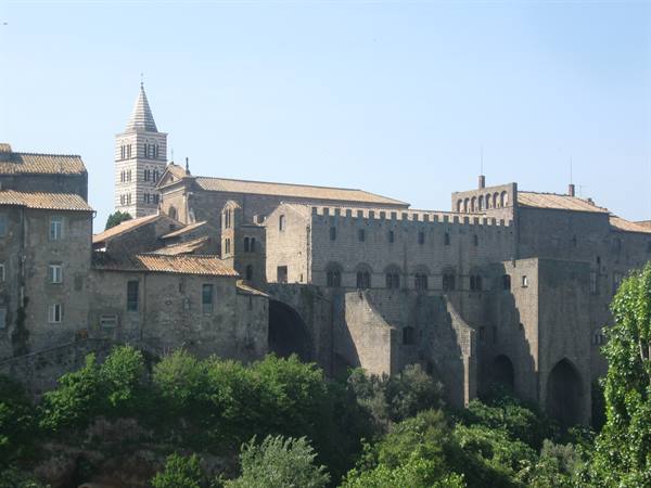 Viterbo Papal Palace and cathedral in stone, slipcovered bell tower, morning light