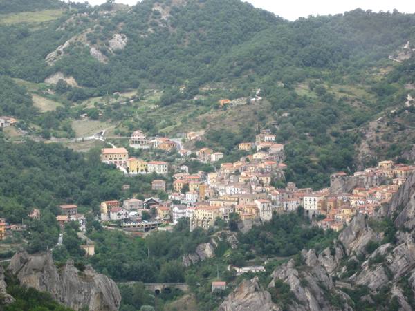 Colorful village houses among woods and rocky peaks, Dolomiti Lucane
