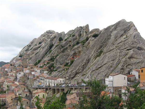Castelmezzano, stone houses built against Lucanian dolomite rocks under cloudy sky
