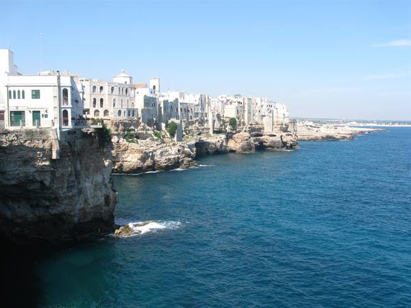 White houses of Polignano a Mare atop limestone cliffs above the blue sea