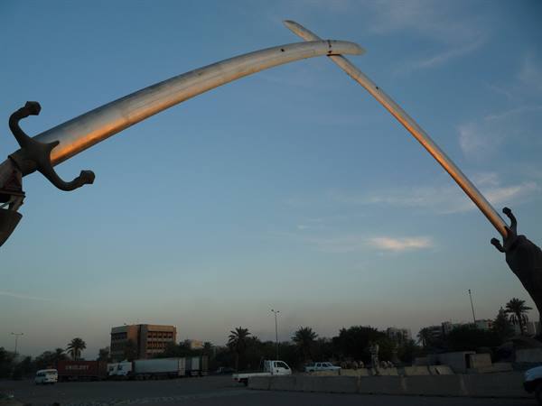 Two crossed steel swords arch over the square in Baghdad