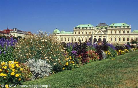 Flower gardens in front of the Belvedere palace in Vienna under blue sky