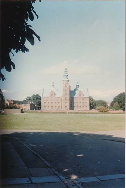 Rosenborg Castle in Copenhagen, red brick facade and green lawn in daylight