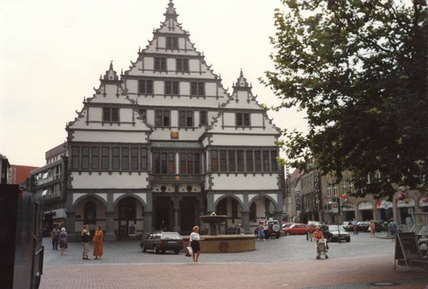 Renaissance town hall of Paderborn, stepped gable facade, people and cars on the square