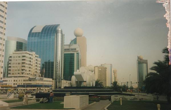 Skyscrapers with golden domes and white monument on Abu Dhabi roundabout