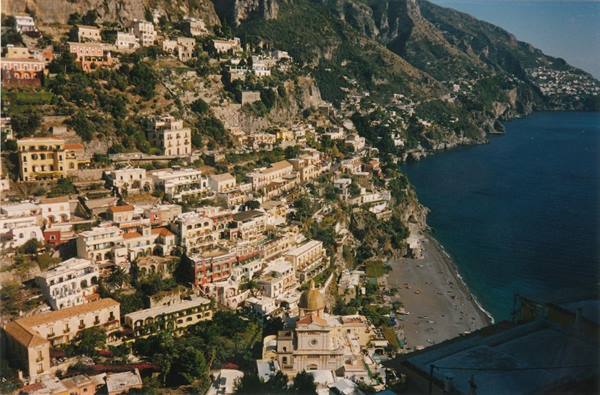 Positano's colorful houses tumble down the cliff toward the beach and blue sea