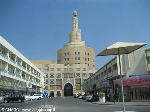 The Fanar spiral minaret in Doha rising above busy shops and traffic
