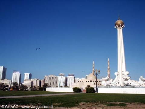 White monument with golden sphere and skyscraper skyline, Abu Dhabi
