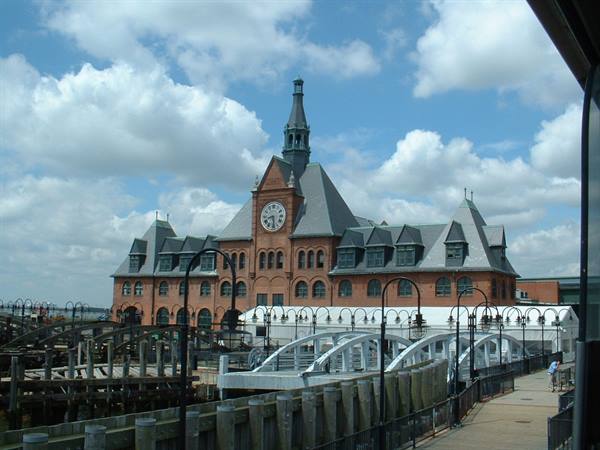 Historic red-brick ferry terminal with clock tower, wooden piers and walkways