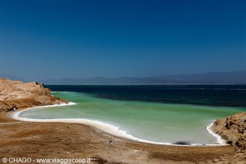 Turquoise salt evaporation pools edged with white salt crust, Dead Sea