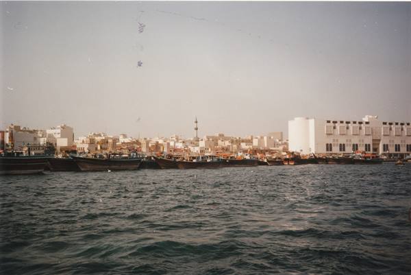 Traditional wooden dhows moored along the Dubai Creek waterfront