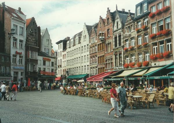 Tourists stroll past café terraces on the Grote Markt in Antwerp