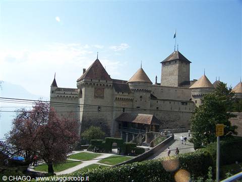 Chillon Castle, medieval stone walls and conical towers above the garden
