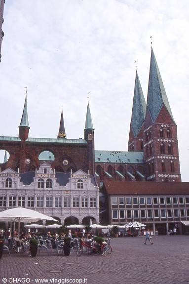 Lübeck market square with outdoor cafés and the spires of St. Mary's Church