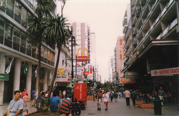 Busy pedestrian street with palm trees, McDonald's sign and buildings, Mar del Plata
