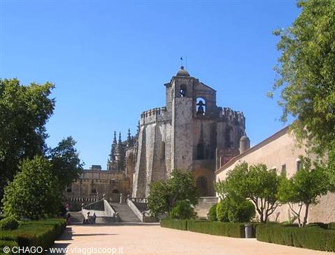 Convent of Christ in Tomar: stone tower with bell tower among trees