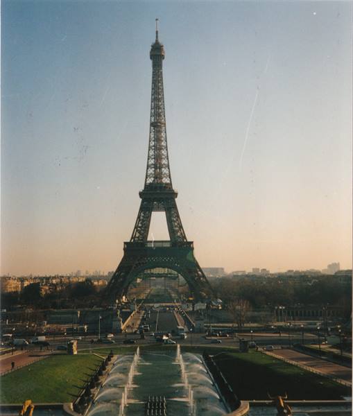 The Eiffel Tower iron lattice seen from Jardins du Trocadéro with fountains and golden light