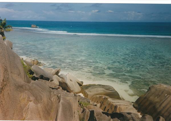 Smooth granite boulders above a turquoise lagoon, La Digue, Seychelles