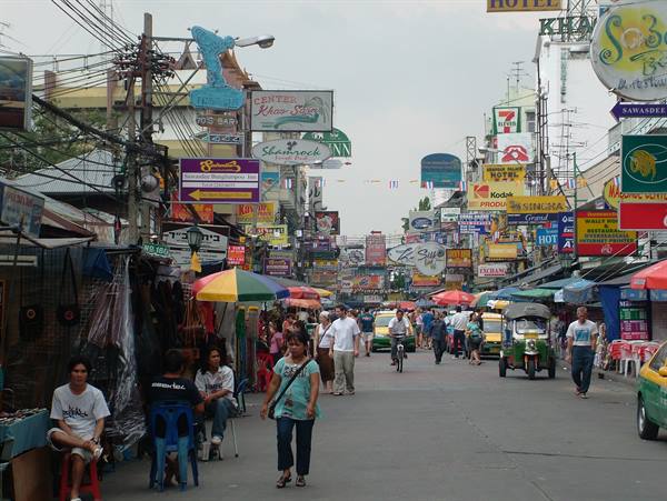 Busy street with colorful signs, umbrellas and tuk-tuks, famous Khao San Road