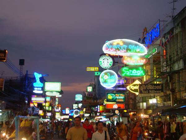 Neon signs glowing over the crowd on Khao San Road, Bangkok