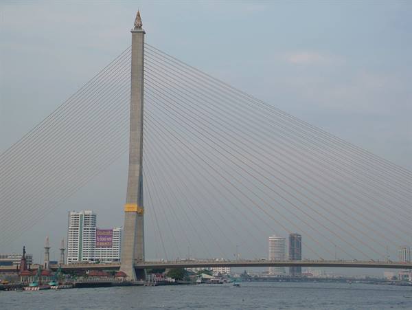 Rama VIII Bridge in Bangkok, concrete pylon with cables, hazy sky over the river