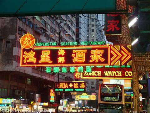 Hong Kong neon signs: seafood restaurant, double-decker bus passing below