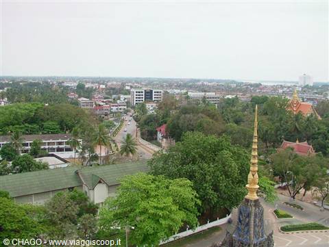 Vientiane: golden temple spire rising above city trees and buildings