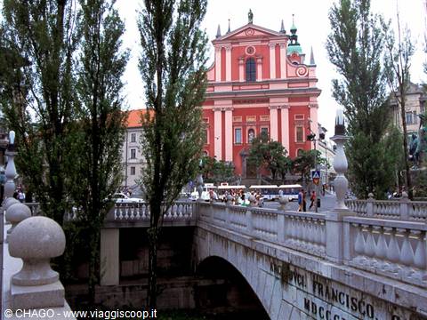 Pink Franciscan church behind stone bridge, Ljubljana