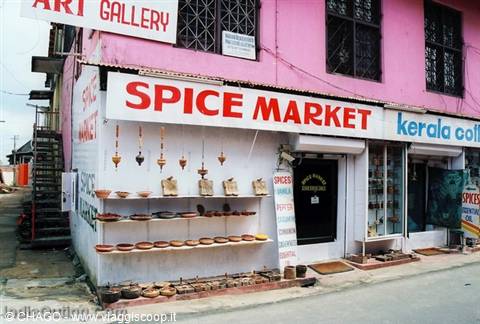 Red Spice Market sign on pink facade, spices and wooden baskets on display