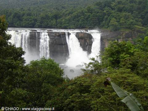 Athirappilly Falls cascading between rocks and lush tropical forest